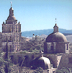 [church domes and bell towers rising above the center plaza of Alamos, Mexico: 26k]