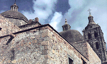 [Massive stone work in the back wall of the church, Alamos, Mexico: 39k]